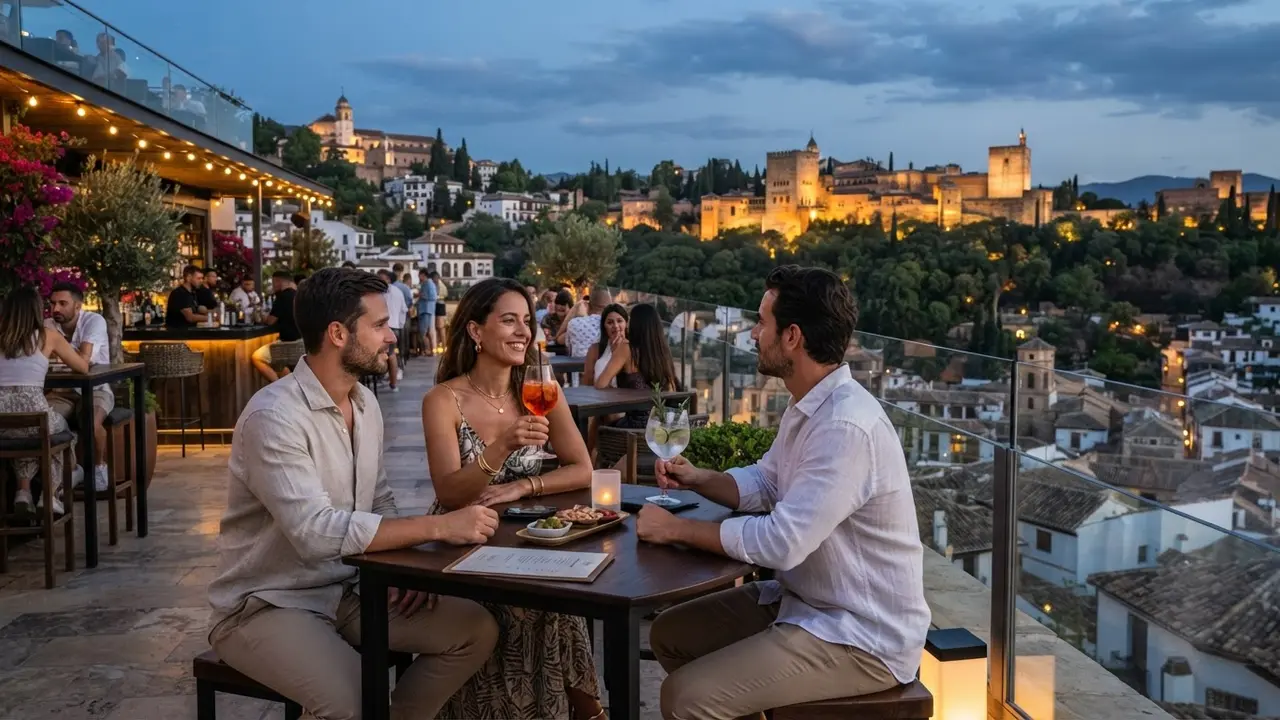 Rooftop cocktail bar in Granada at dusk with views over the Alhambra and Albaicín