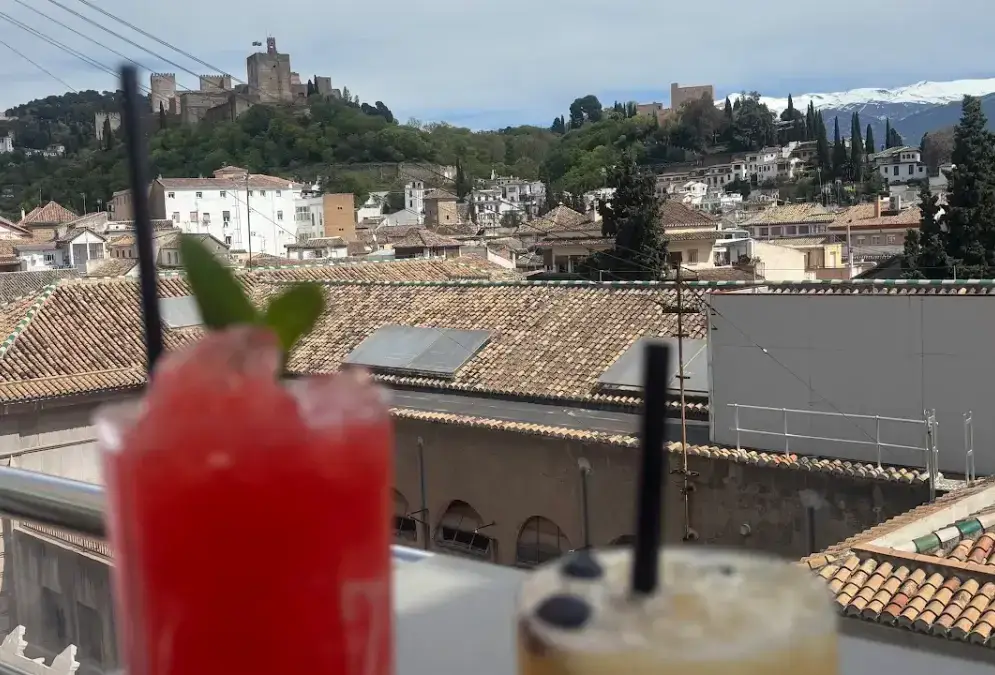 Rooftop terrace of Eurostars Gran Vía with views across Granada toward the Alhambra at dusk