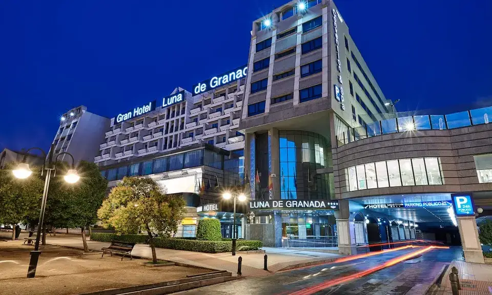 Gran Hotel Luna de Granada exterior with outdoor pool and garden in summer