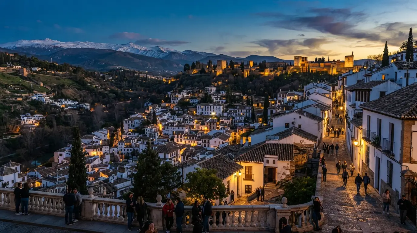 The Albaicin hill in Granada at dusk, whitewashed houses climbing the slope where 9th-century Gharnāṭa was first recorded, the granada spain name origin etymology history debate rooted in this exact topography