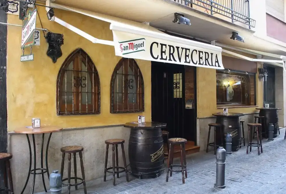 Interior of La Riviera Granada bar with eclectic decor and suit of armour